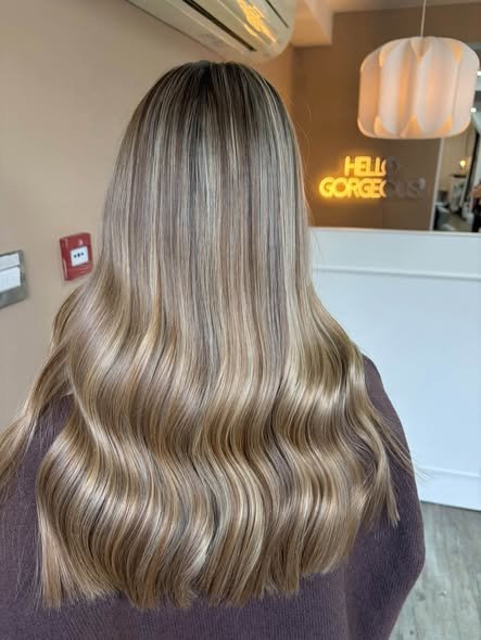 Dimensional blonde colour and soft waves created at Vanity Hair by Design