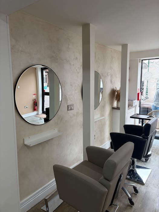 Vanity Hair salon interior with styling chairs and circular mirrors